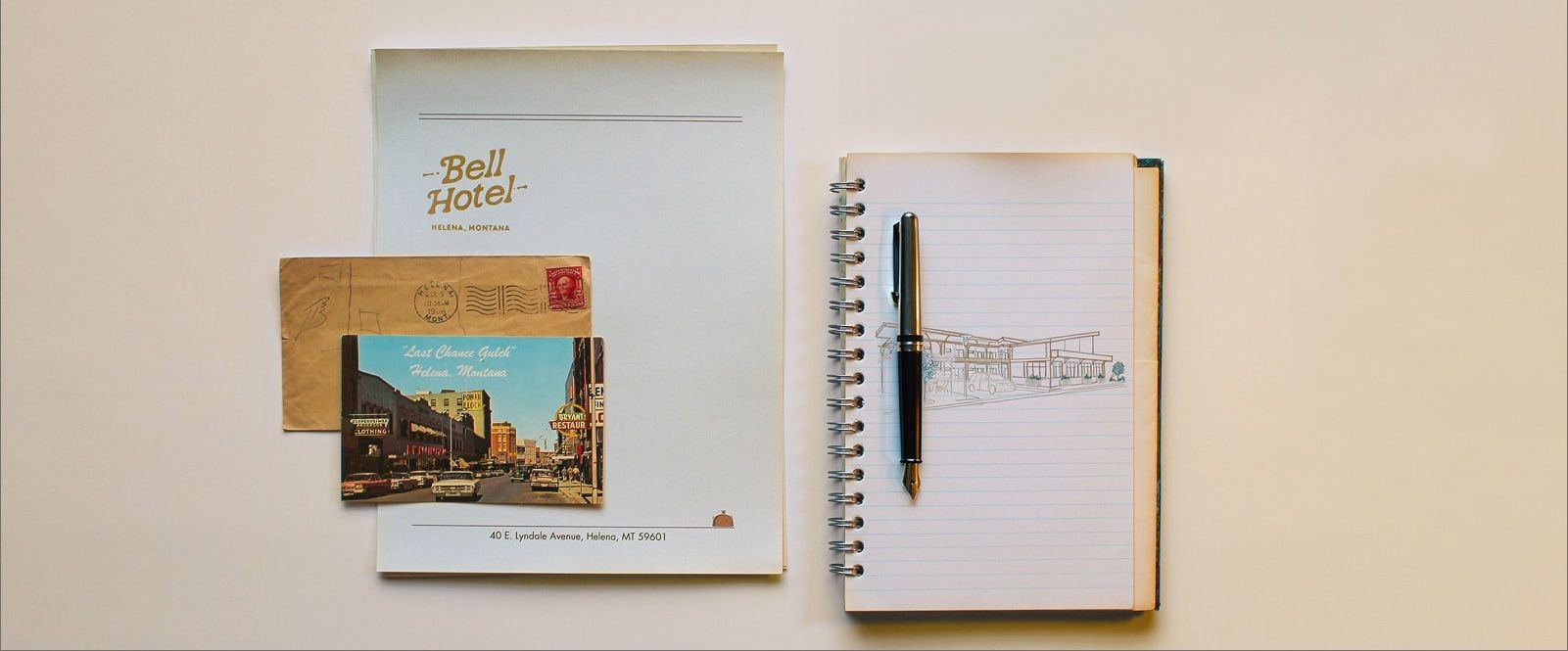 A collage of Bell Hotel stationary, a Helena postcard and a notebook with a drawing of an old motel.